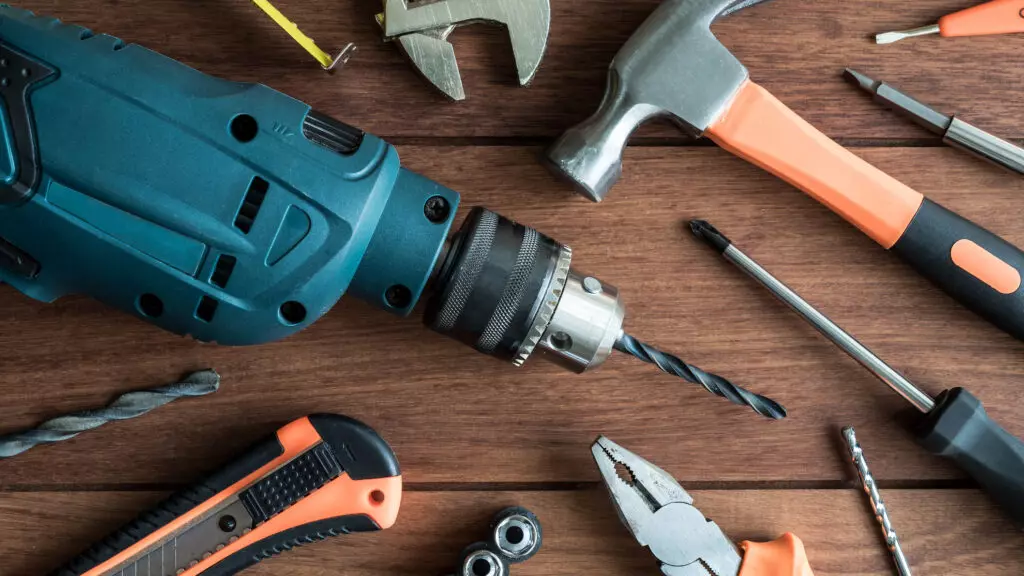 Set of work tools on wooden background