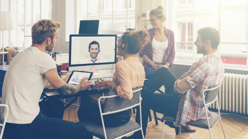 people attend an online event from their office